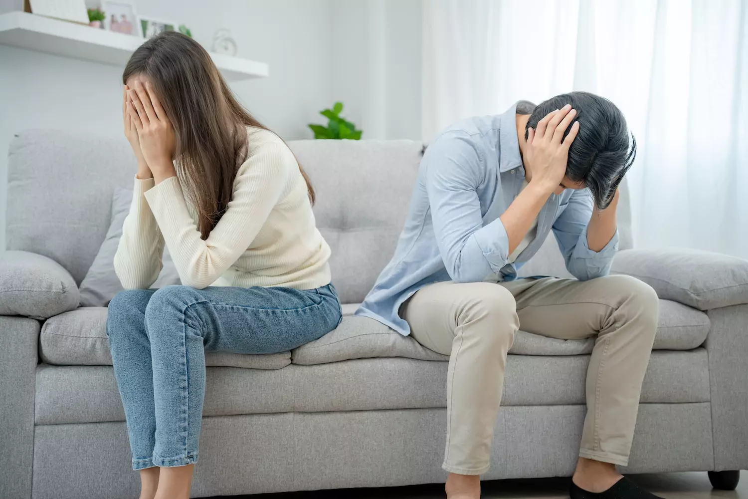Couple sitting together stressed during an online counselling session